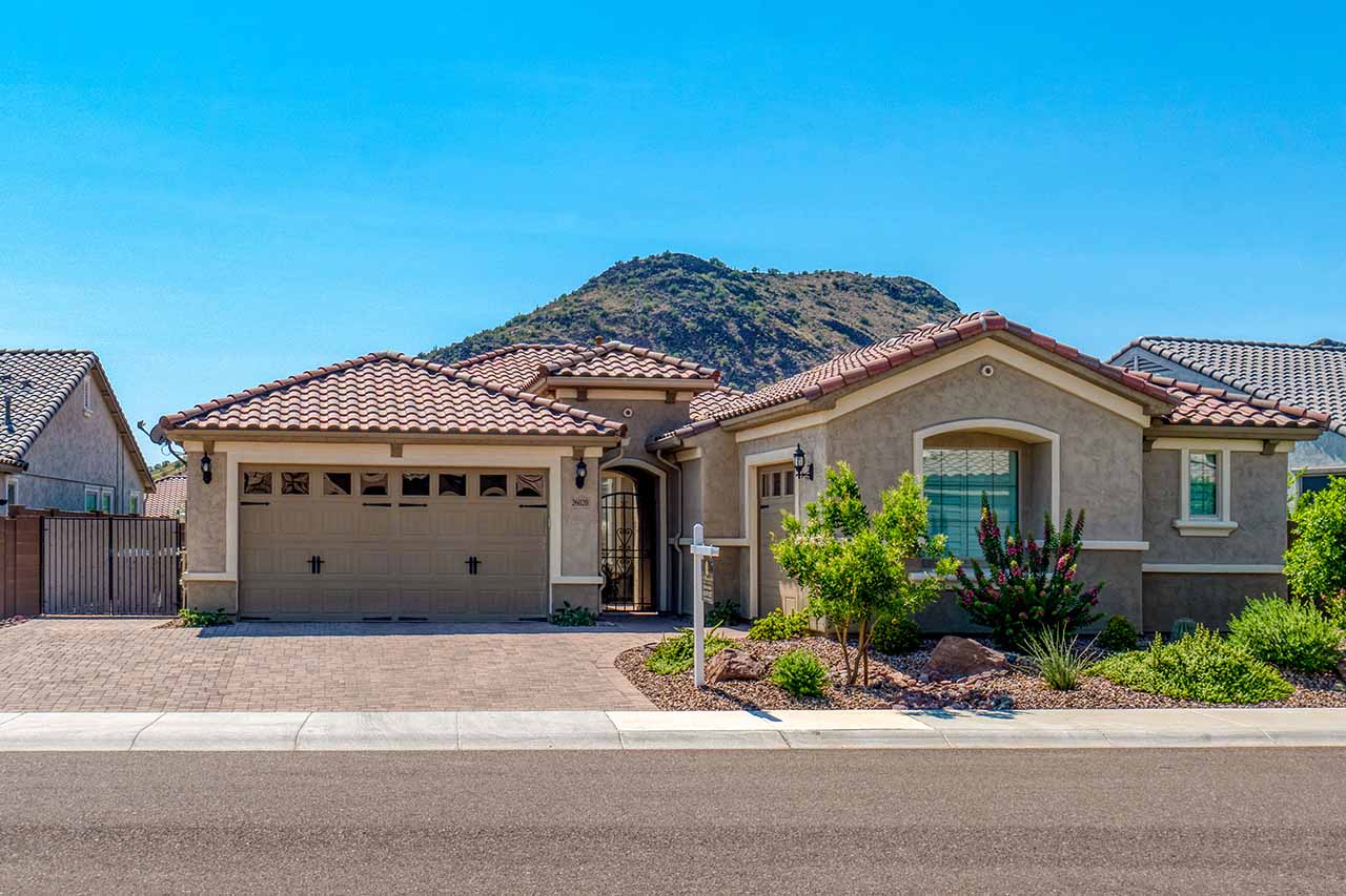 Single-story Arizona home with tile roof and mountain views, reflecting typical Phoenix Metro real estate.