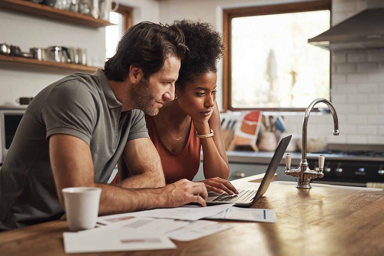 Happy couple celebrating in their new Phoenix Metro home, symbolizing a successful home-buying experience.