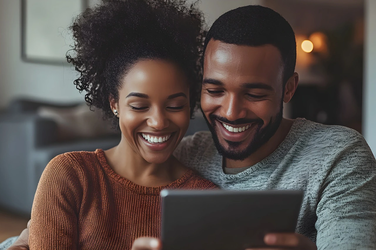 Arizona homeowners reviewing refinance options on a tablet before making a mortgage decision