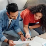 Arizona homeowners reviewing refinance documents and mortgage costs before deciding whether to refinance