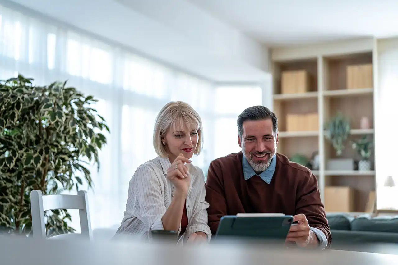 Arizona homeowners reviewing home equity and mortgage options together on a tablet